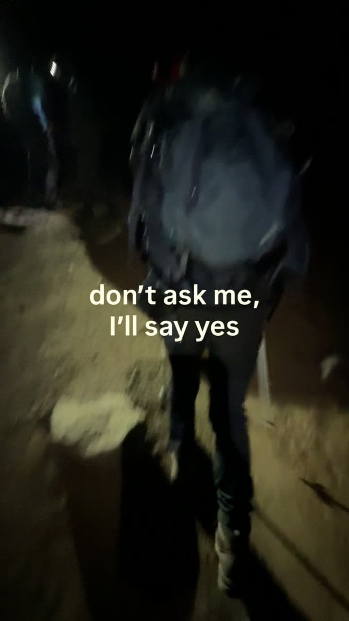 Makenna walking down a dark path with a backpack, text overlay reading 'don't ask me, I'll say yes'