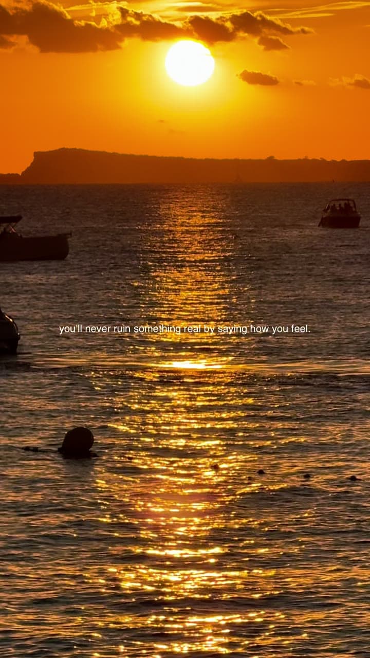 A golden sunset over the sea with boats, text reading 'you'll never ruin something real by saying how you feel'