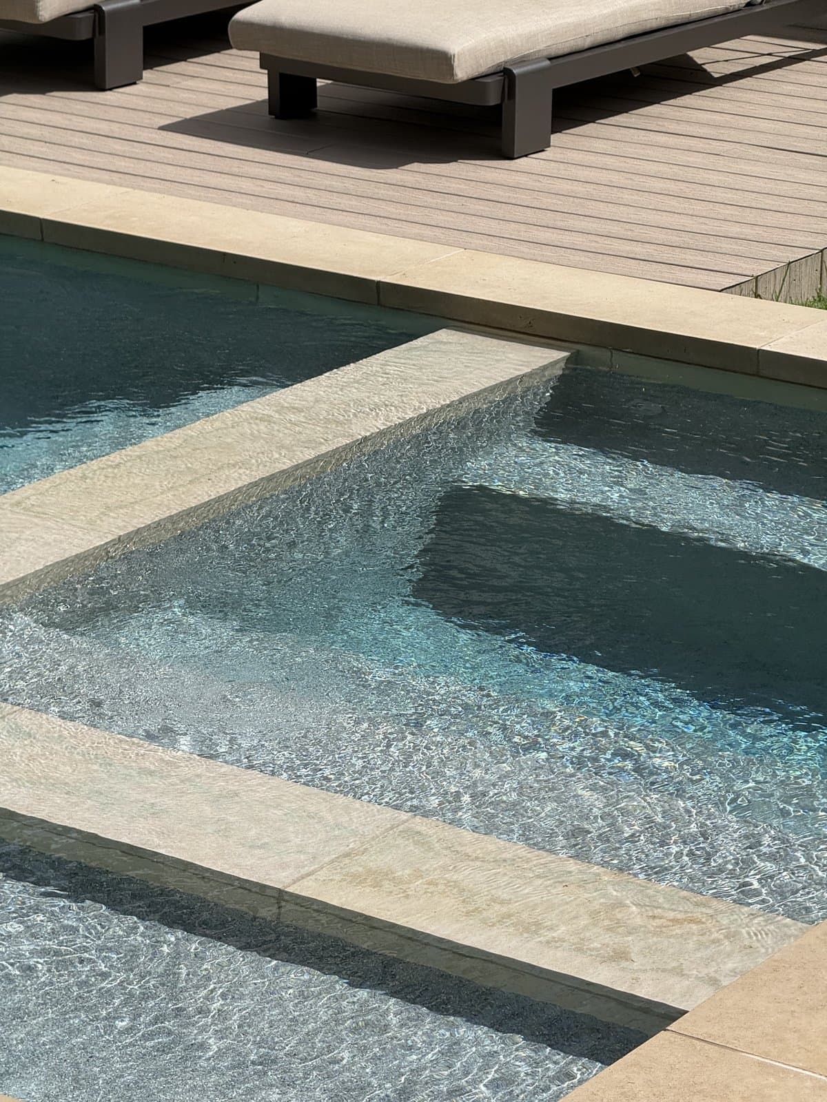 A pool deck detail shot with clear blue water