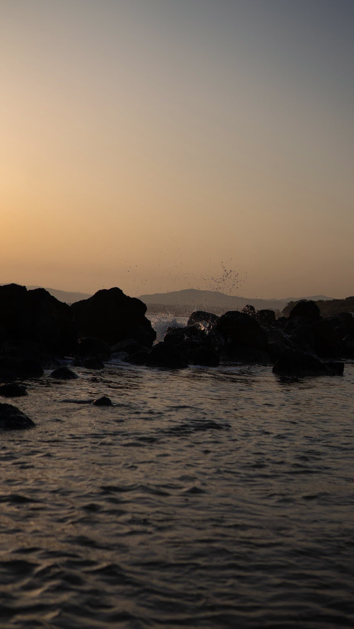 Sunset light over rocks on the beach